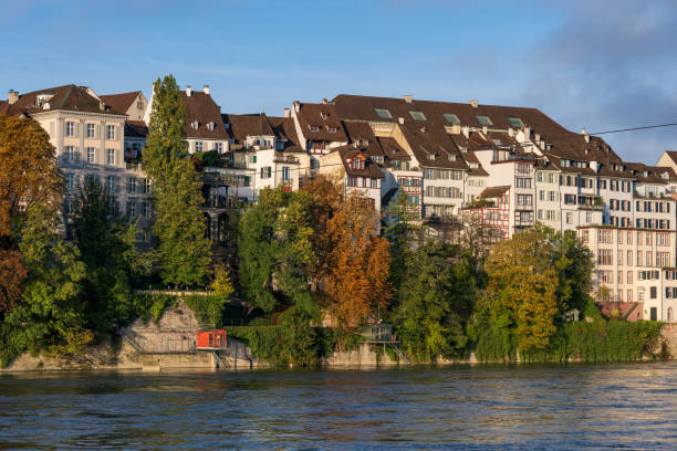 City of Basel in Switzerland, riverside apartment buildings at Rhine River in autumn.