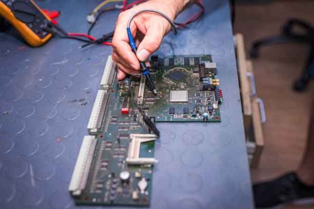 A close-up of a technician using a soldering tool to repair a printed circuit board. The image captures precision and technical expertise in electronics maintenance.