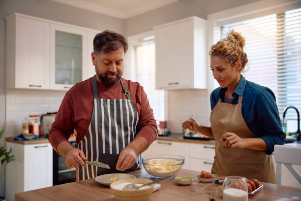 istock Mid adult couple baking together in the kitchen. 2181502364
