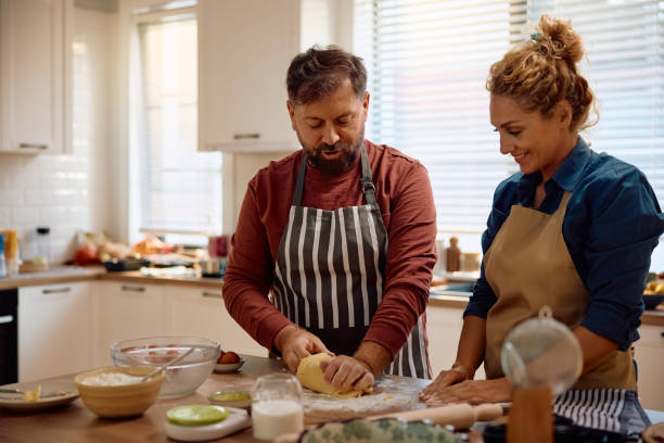istock Happy couple making a cake in the kitchen. 2181502416