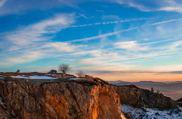 Breathtaking mountain landscape during sunrise, showcasing rocky cliffs and a vibrant sky. Experience tranquility and natural beauty in this picturesque scene.