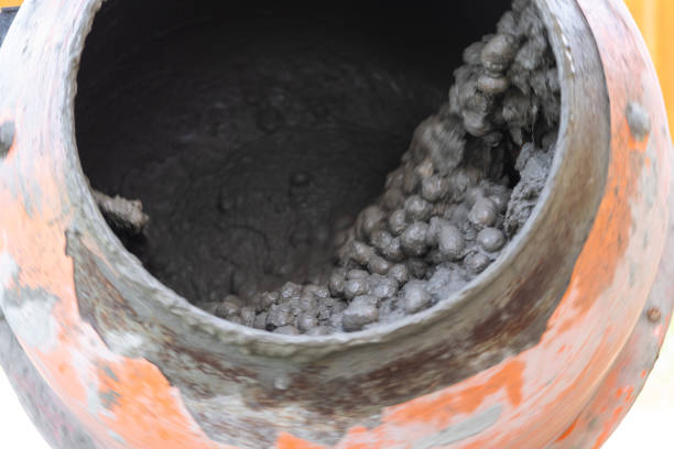 istock Mixing mortar in a handheld portable concrete mixer 2181504572