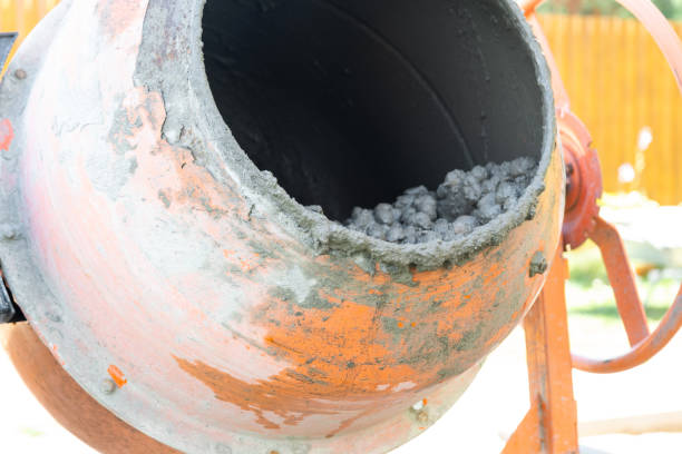 istock Mixing mortar in a handheld portable concrete mixer 2181504581