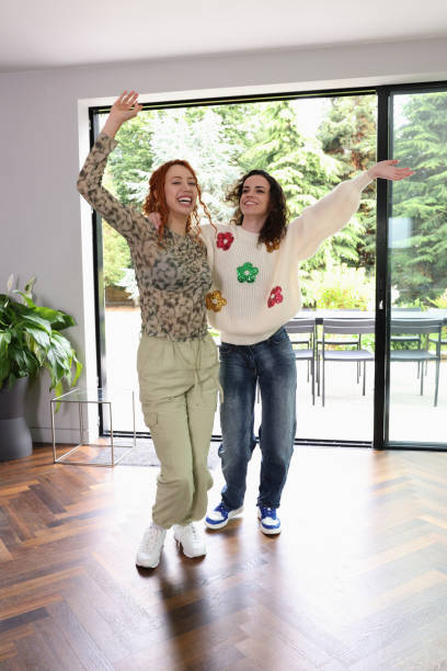 istock Women embracing and waving at home 2181508355