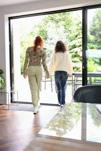 istock Women holding hands on patio 2181508357