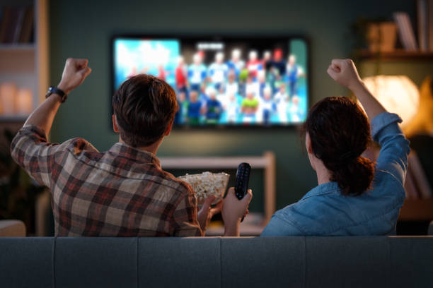 istock couple with popcorn sitting on sofa 2181508597