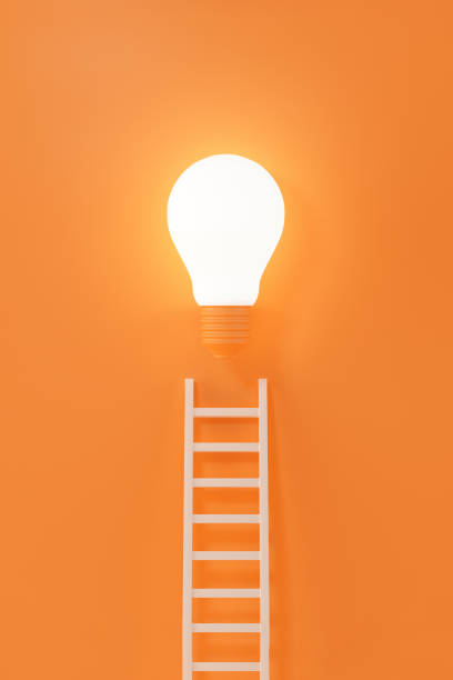 istock Ladder reaches up to a lit light bulb representing an Idea, creativity, invention concept. 3d rendering. 2181510094