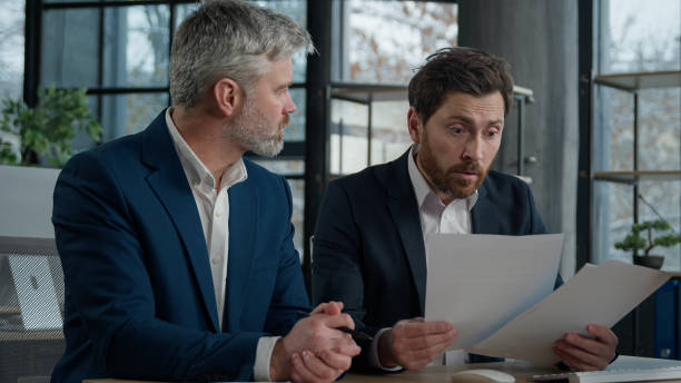 istock Nervous angry man boss argue scolds employee because mistake in documents financial papers Caucasian men businessmen arguing in office meeting business conflict problem mistake work failure bad result 2181519838