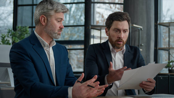 istock Nervous angry man boss argue scolds employee because mistake in documents financial papers Caucasian men businessmen arguing in office meeting business conflict problem mistake work failure bad result 2181520135