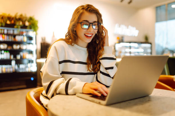 istock Young woman sitting on cafe with laptop. 2181521938