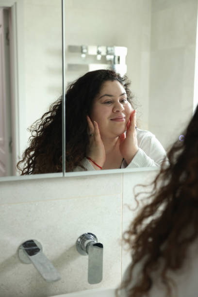 istock Woman reflecting in bathroom mirror 2181522061