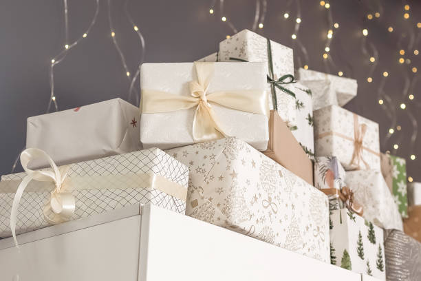 istock Presents neatly stacked on a shelf adorned with festive decorations and warm lighting during the holiday season 2181523151