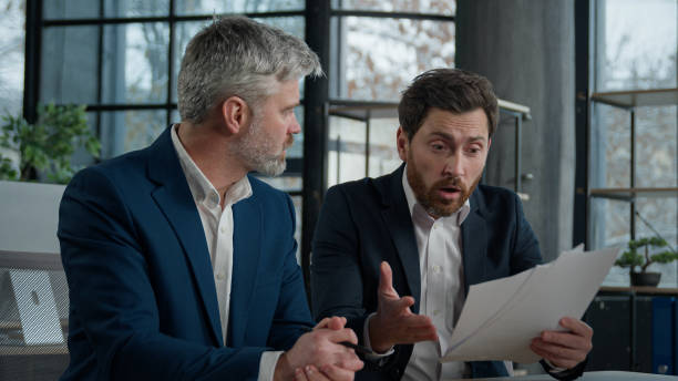 istock Nervous angry man boss argue scolds employee because mistake in documents financial papers Caucasian men businessmen arguing in office meeting business conflict problem mistake work failure bad result 2181524107