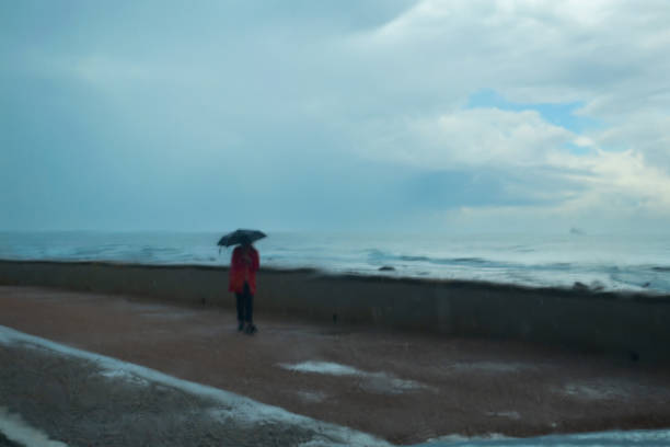 istock Solitary Figure with Umbrella Distorted by Raindrops on a Rainy day 2181528826
