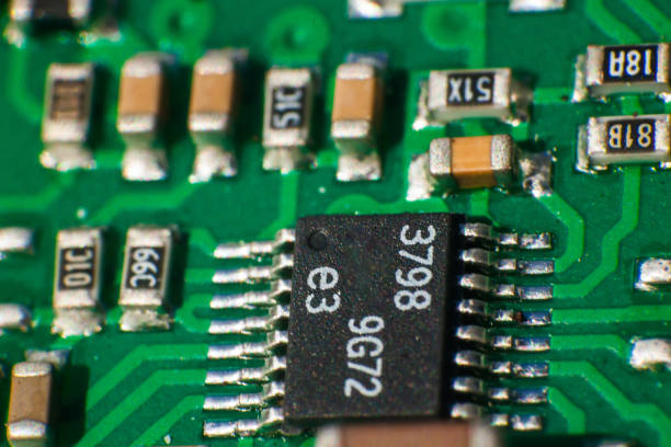 Computer board with soldered chips and semiconductors, close-up.