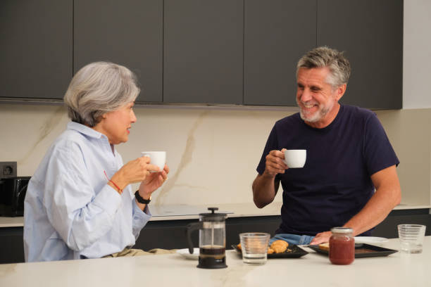 istock Senior couple enjoying coffee and breakfast in modern kitchen 2181529885
