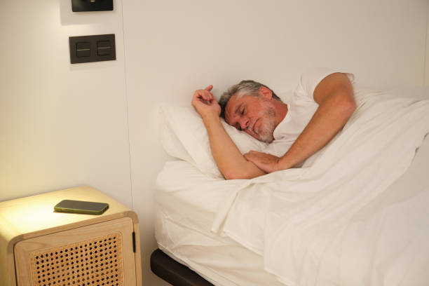 istock Senior man sleeping peacefully in comfortable bed at home 2181529917