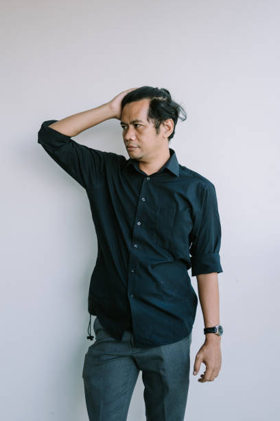 istock Southeast Asian man holding his head with a thoughtful expression 2181530505