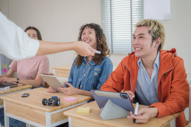 High angle view of a diverse group of elementary school kids sitting on chairs in a circle and interacting during a lesson, one Caucasian girl talking while her classmates listen