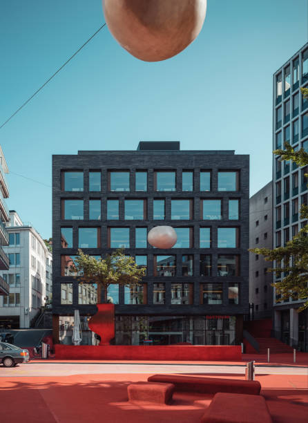 Stadtlounge - public space on a square in town covered with red carpet. Modern business center in the background. St Gallen, Switzerland - September 19 2019.