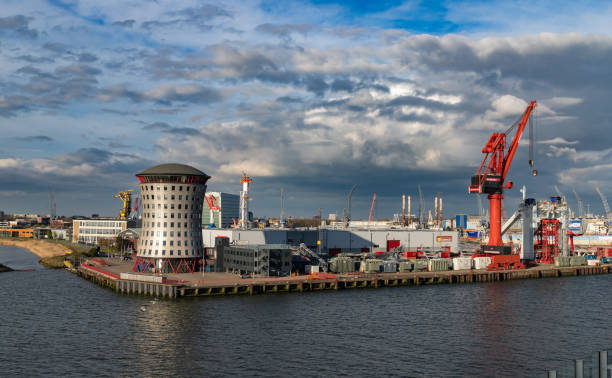Rotterdam, Netherlands - April 1, 2024: Rotterdams port with cranes, vessels, and warehouses, reflecting the citys dynamic blend of logistics, maritime engineering, and commerce.
