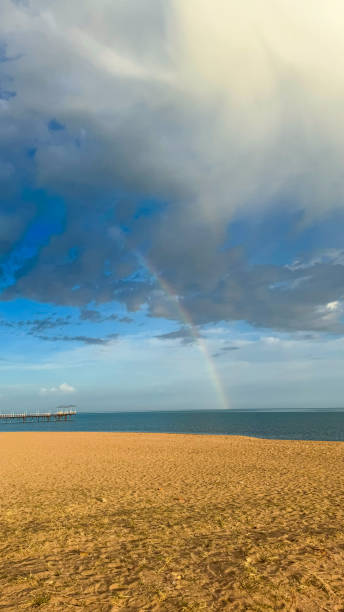 istock Rainbow on the seashore. Sky after rain and sand. 2181538359