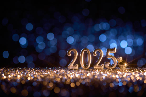 istock Golden 2025 numbers on glitter surface with blue bokeh lights in the background, representing New Year celebration and festive holiday spirit. 2181539573