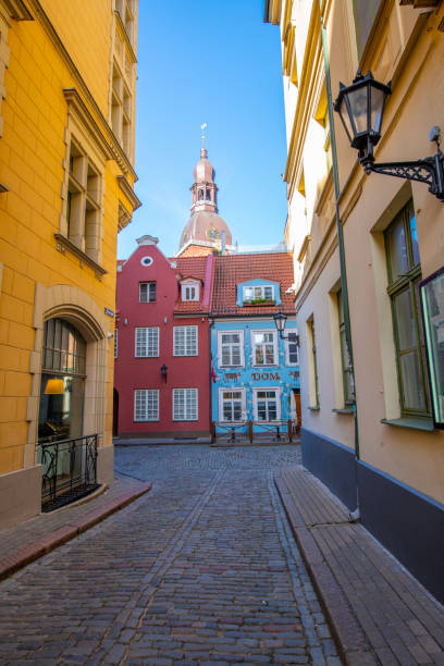Narrow alley facing colorful houses of Riga, Latvia.