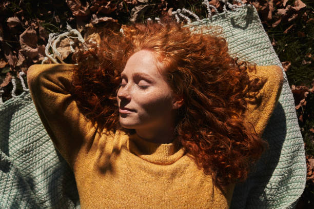 istock Woman Relaxing on Blanket in Autumn Park 2181542797