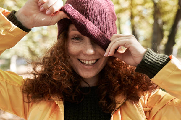 istock Playful Woman Adjusting Her Hat in Autumn 2181542983
