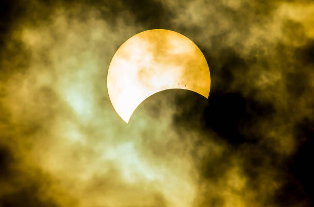 istock A yellow sun is seen behind a cloudy sky 2181543906