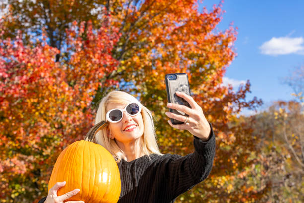 istock Woman Taking Fall Selfie With Pumpkin 2181544093