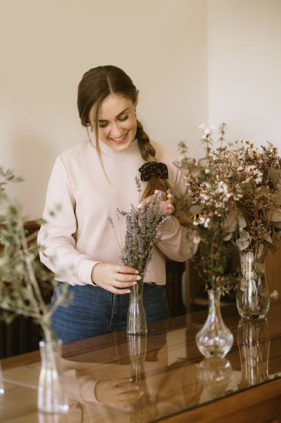 istock Woman arranging dried flowers 2181549055