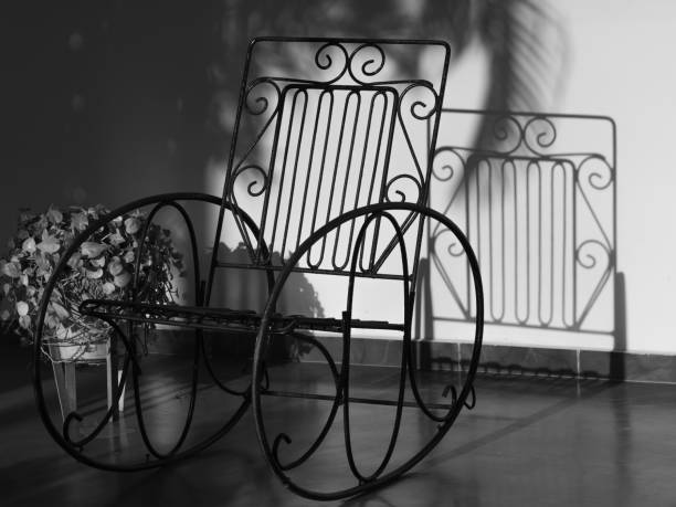 Rocking chair. Wooden rocking chair with soft cushions with minimalistic linear nature pattern