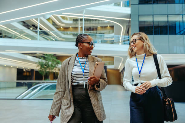 istock Successful young accountants walking and talking in a modern office environment 2181550307