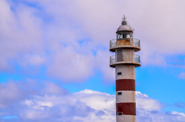 istock A lighthouse is standing tall in the sky with a cloudy background 2181550506