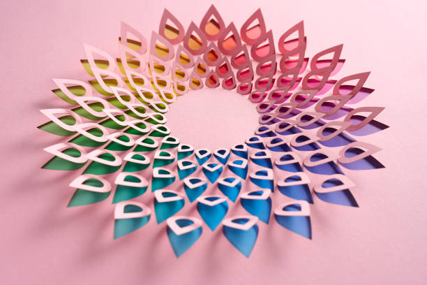 istock Delicate Paper Cutout Mandala with Petal Shapes in a Rainbow Gradient on Soft Pink Background 2181553371