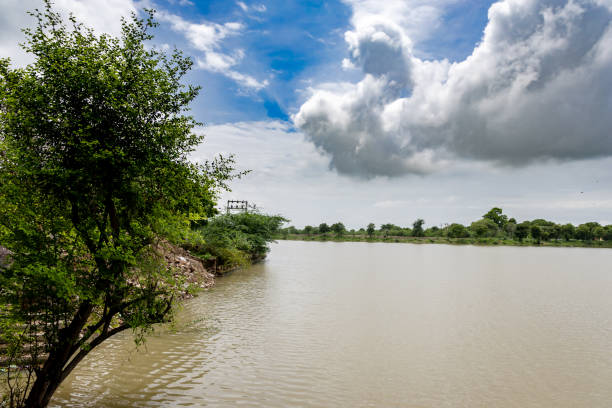 istock Flooded River Muddy Water with Bright blue Sky at morning 2181553738