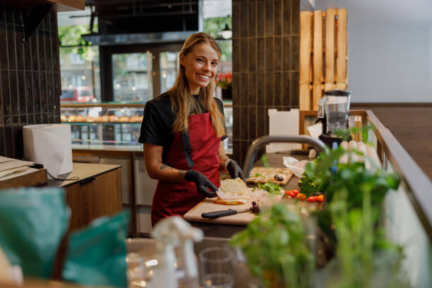 istock A Cheerful and Smiling Chef Skillfully Preparing Fresh Ingredients in a Modern Kitchen 2181558657
