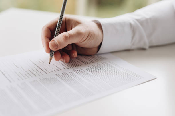 istock Exam. A man writes a test. close-up. 2181559023