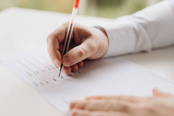 istock Exam. A man writes a test. close-up. 2181559099