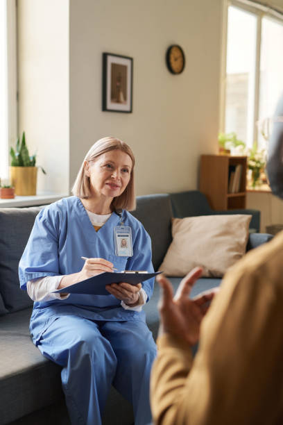 istock Smiling Female Doctor Holding Clipboard 2181559328