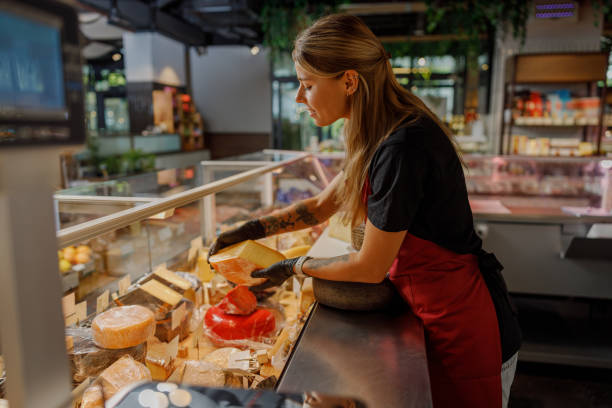 istock A Cheese Vendor Delightfully Serving Customers at a Modern and Elegant Deli Setting 2181561068