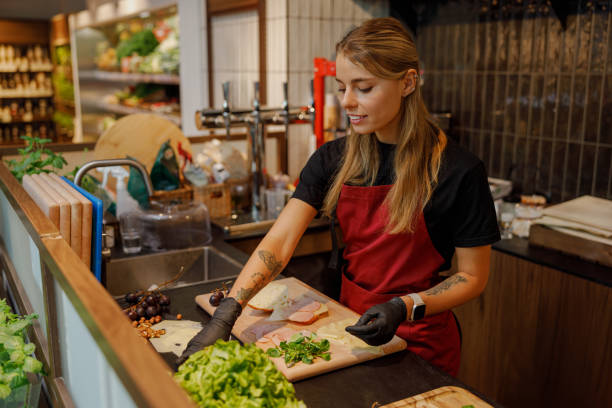 istock A young woman diligently preparing fresh, vibrant ingredients in her lively kitchen environment 2181561226