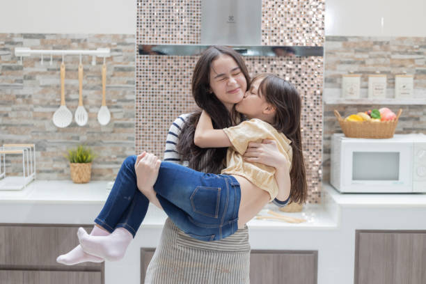istock Two sisters hug and kiss each other with love 2181562138