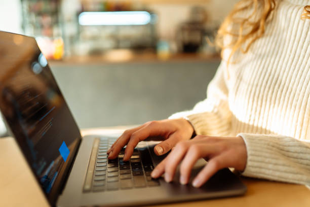 istock Close-up of hands working on a laptop keyboard. 2181563978