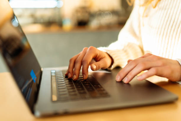 istock Close-up of hands working on a laptop keyboard. 2181563999