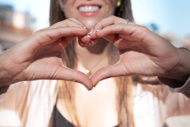 istock Woman Making Heart Shape with Hands 2181564897
