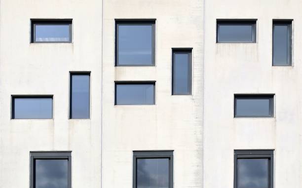 istock Pvc windows with different shapes and size on a precast concrete facade. 2181565497