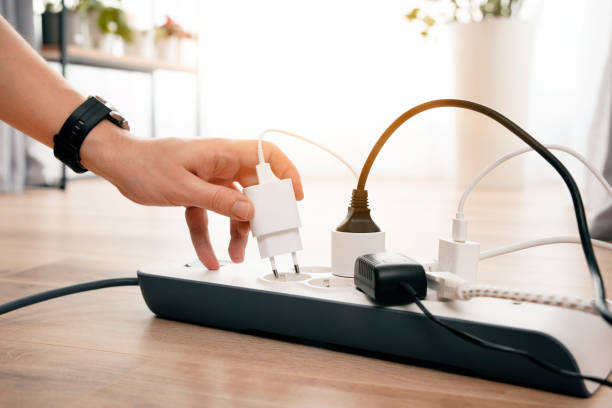 istock Person is plugging in a device to a power strip 2181566814